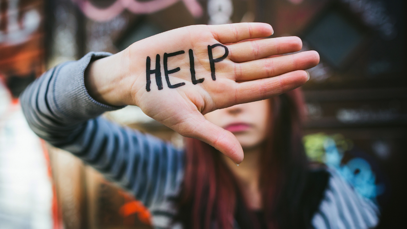 the word help written on a female hand